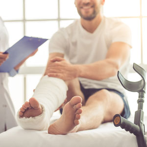 A man with a leg cast sits in a hospital room, reflecting on his medical treatment following an accident in Polk County. - Russo Law