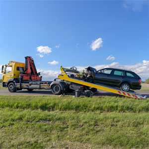 Car accident recovery in Florida: Tow trucks assisting with a damaged vehicle