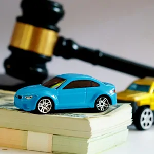 Florida Car Value: Toy car on stacks of cash next to a legal gavel representing diminished value claims.